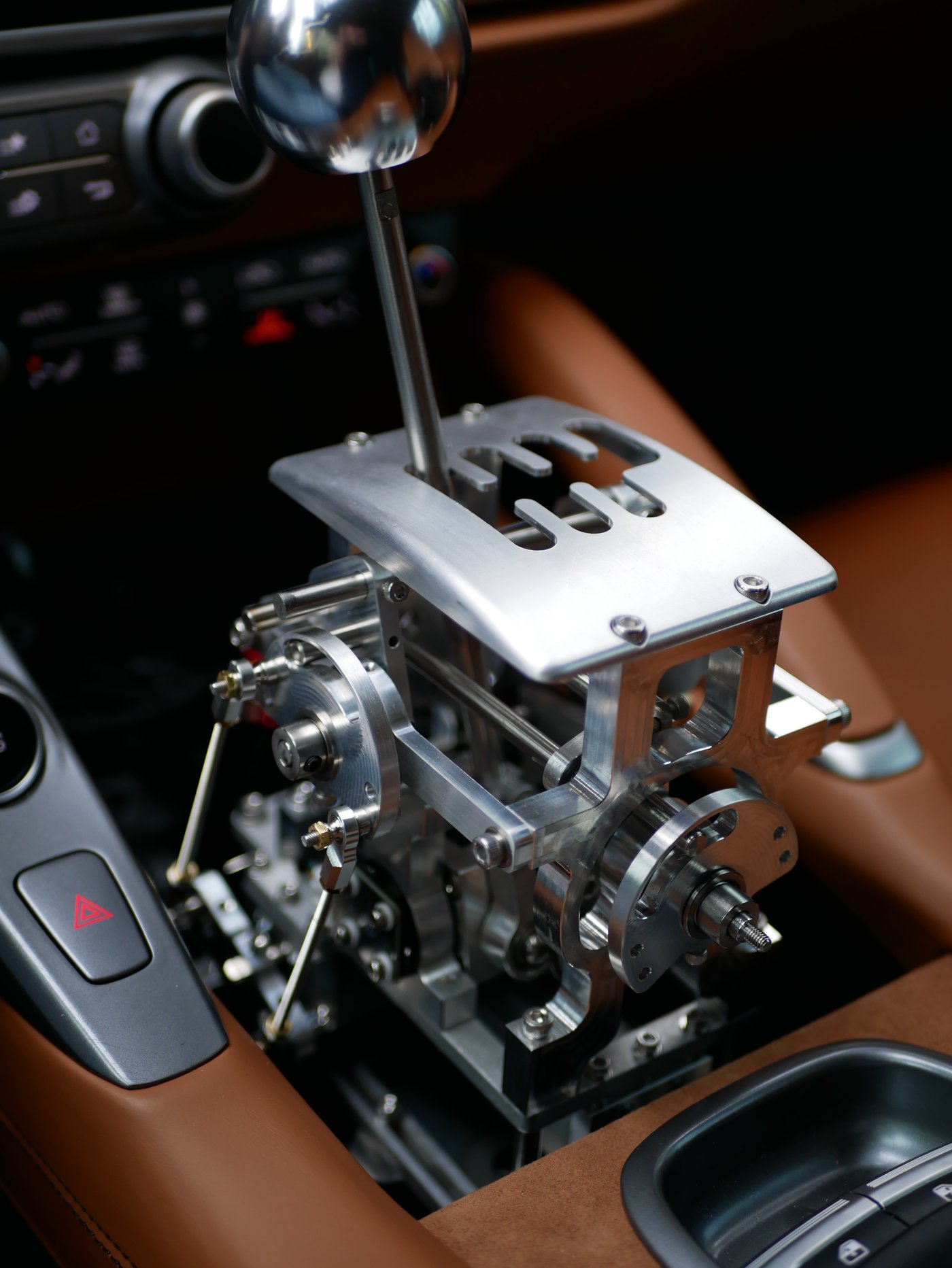 The polished H-gate mechanism installed in the centre console of the GTC4 Lusso, set against cognac leather.